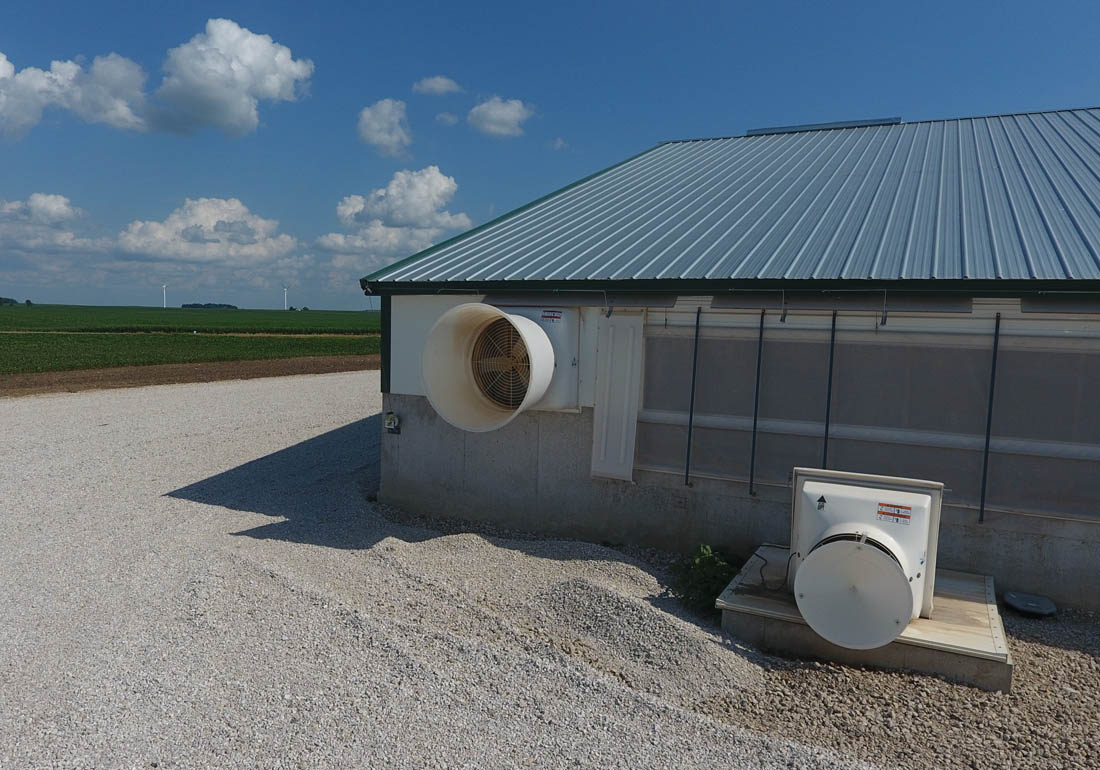 36” GrowerSELECT AirStorm fiberglass fan mounted to the sidewall of the barn and 24” GrowerSELECT AirStorm fiberglass fan for deep pit ventilation with wind deflector.